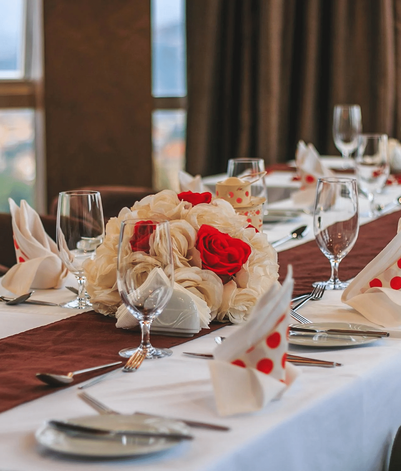 Image of a dining table with crockery and napkins placed on it.